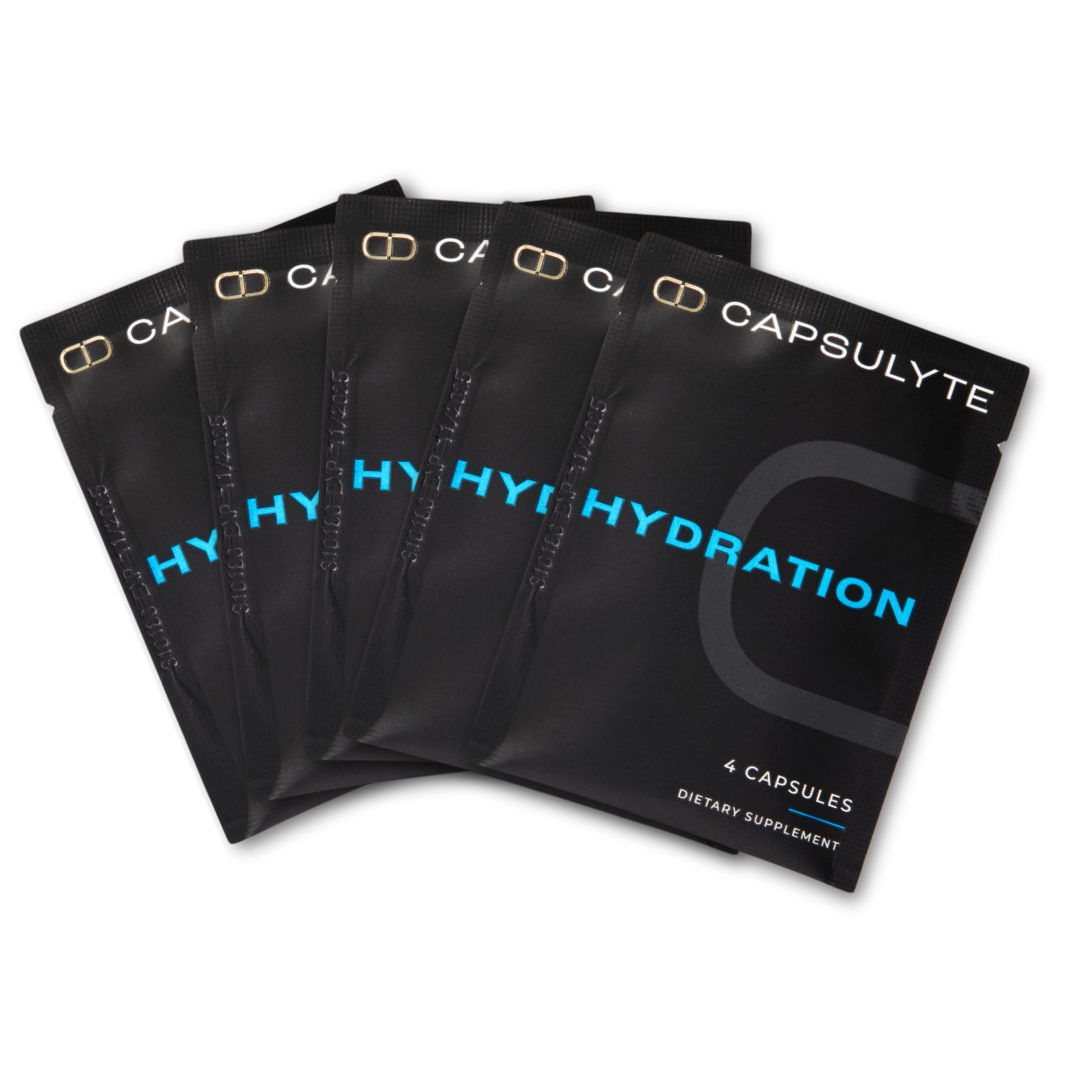 Five black sachets of Capsulyte Hydration dietary supplement, each containing 4 capsules designed for hydration and hangover prevention. The sleek packaging emphasizes convenience and effectiveness.